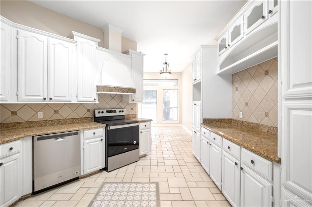 3814 B Shea Weslaco, TX 78596 - Photo 9 of 43 a kitchen with granite countertop white cabinets and white appliances