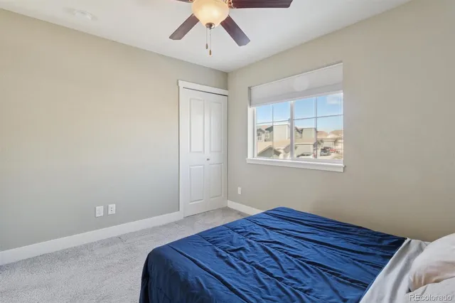 a bedroom with a bed and a painting on the wall