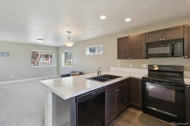 a kitchen with a stove sink and microwave