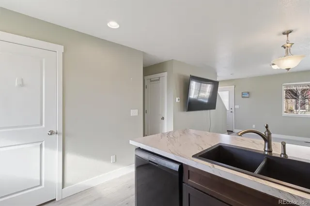 a en suite bathroom with a granite countertop sink and a mirror