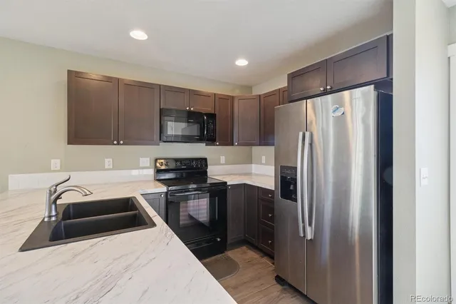 a kitchen with a refrigerator sink and microwave