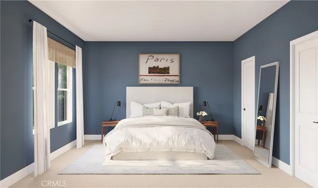 a large bed sitting in a bedroom next to a window