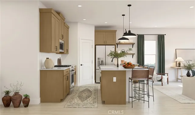 a kitchen with kitchen island a stove a sink a dining table and chairs with wooden floor