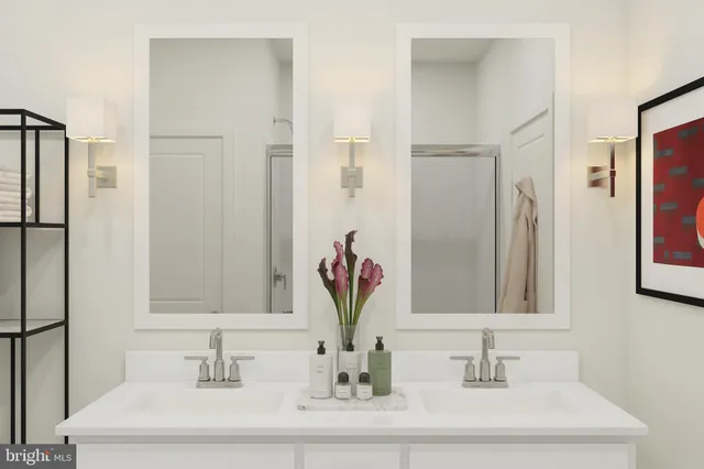 a bathroom with double vanity sinks a vanity and a mirror