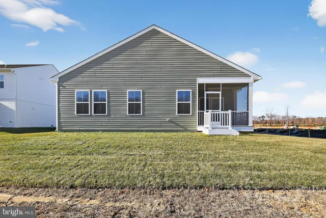 a view of an empty room with wooden floor and closet