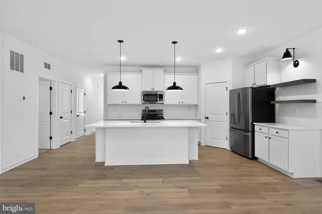 a kitchen with a sink a stove and a refrigerator