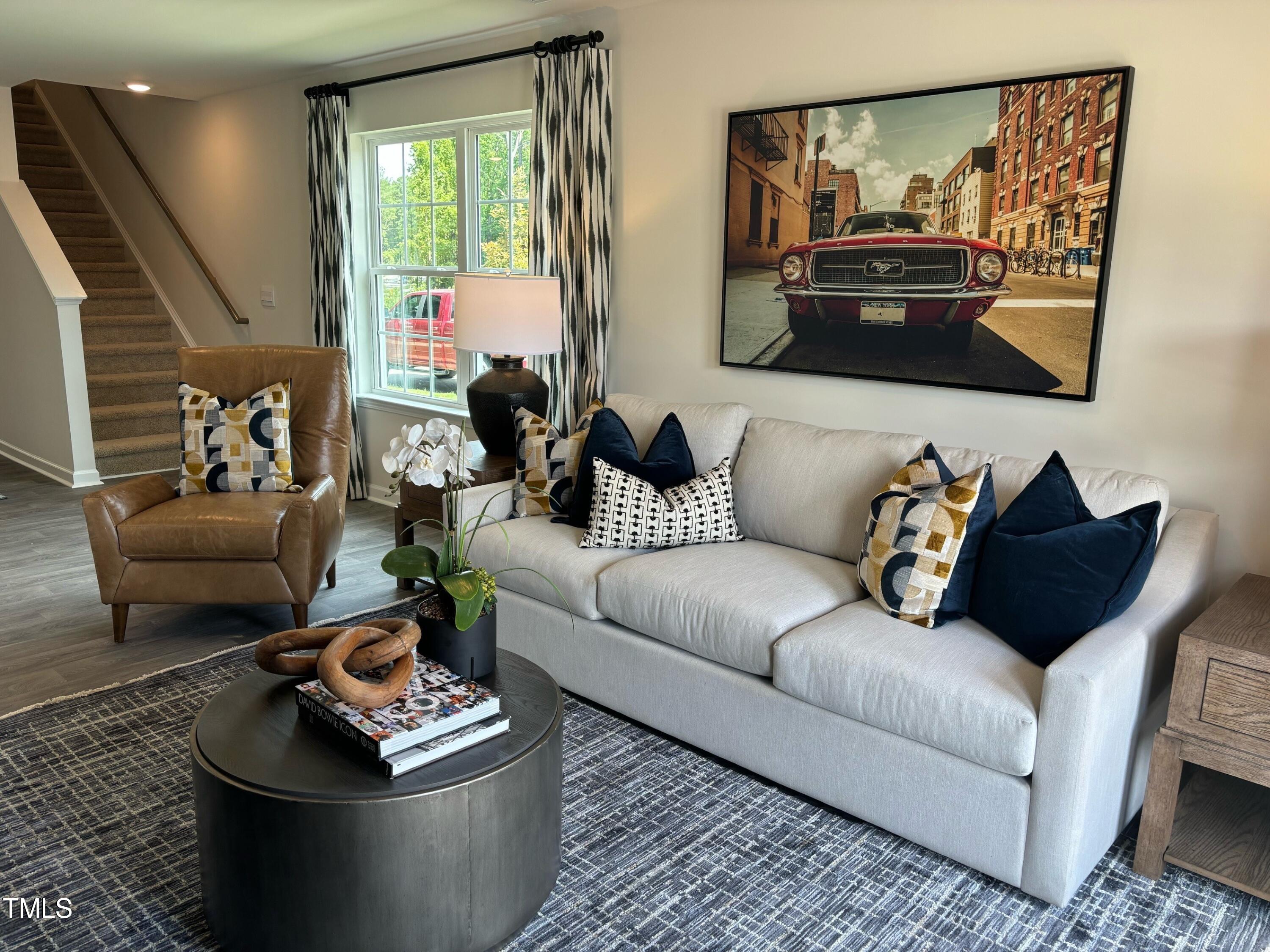 8734 Asher Gray Way Raleigh, NC 27616 - Photo 2 of 22 a living room with furniture and a flat screen tv
