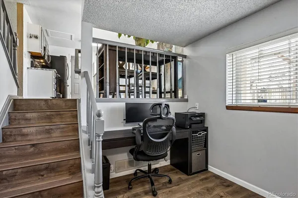 a view of entryway with workspace and windows