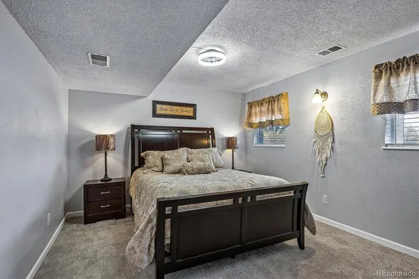 a bedroom with a bed and a night stand