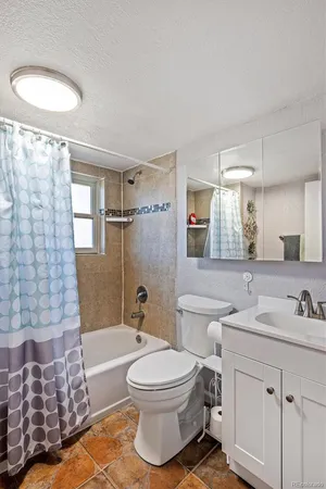 a bathroom with a sink toilet a mirror and shower