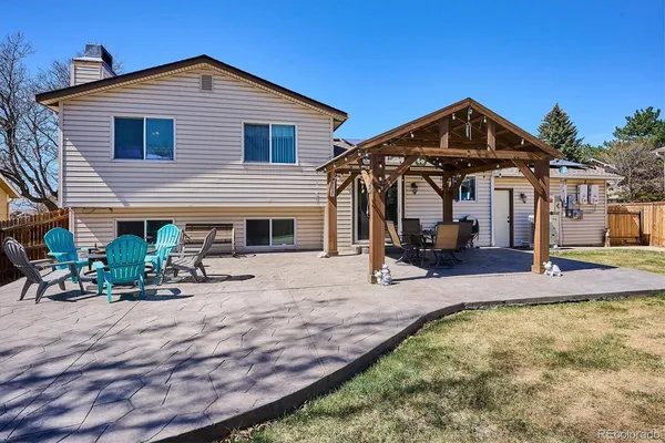 a view of house with yard and sitting area