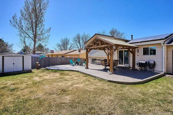 a view of a house with backyard and sitting area