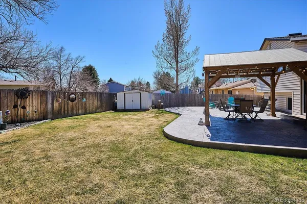 a view of a house with backyard and sitting area
