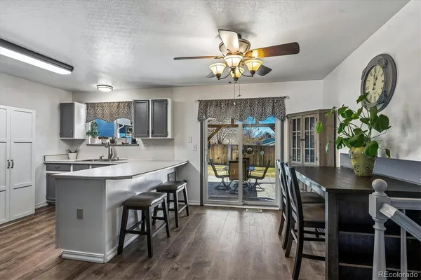 a view of a dining room with furniture a chandelier and wooden floor