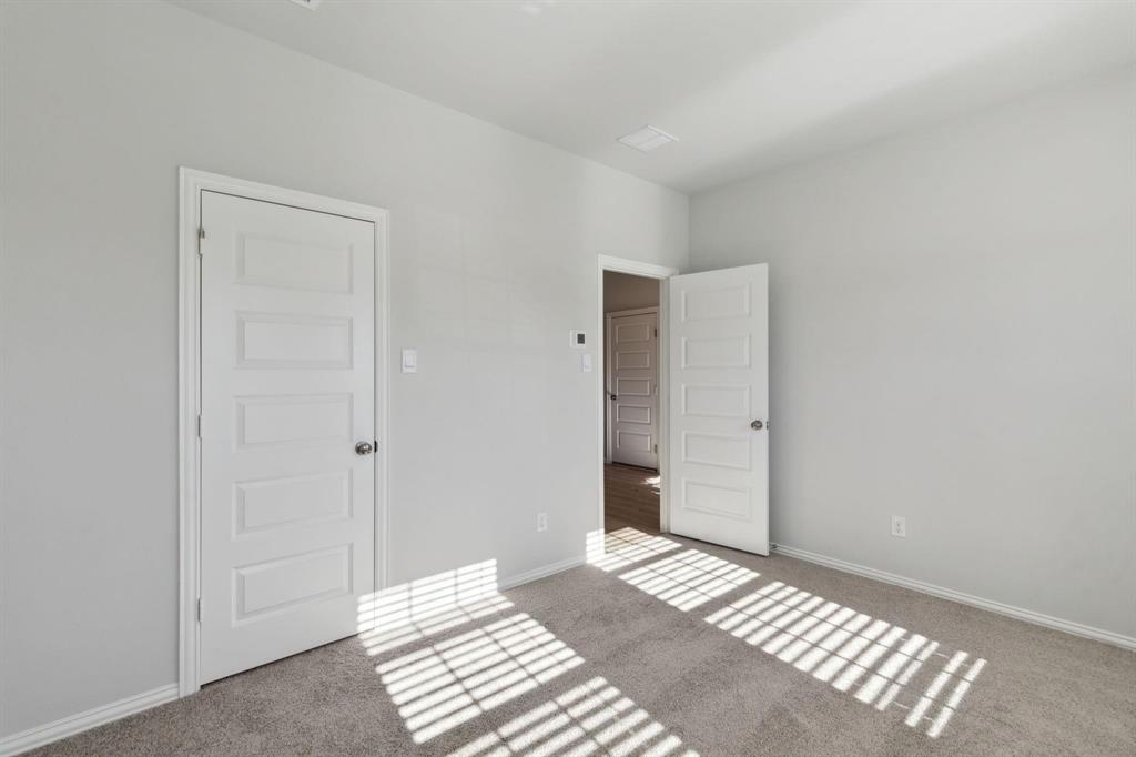 Carpeted spare room with baseboards