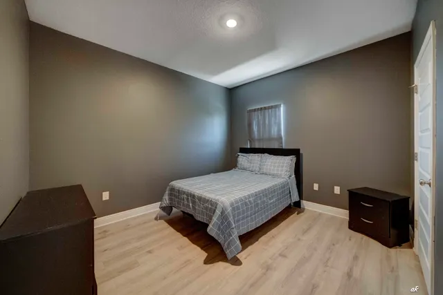 a bedroom with a bed and a lamp