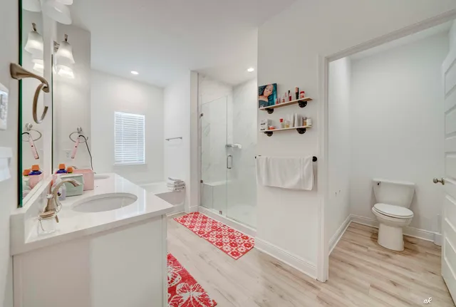 a spacious bathroom with a sink mirror vanity and toilet