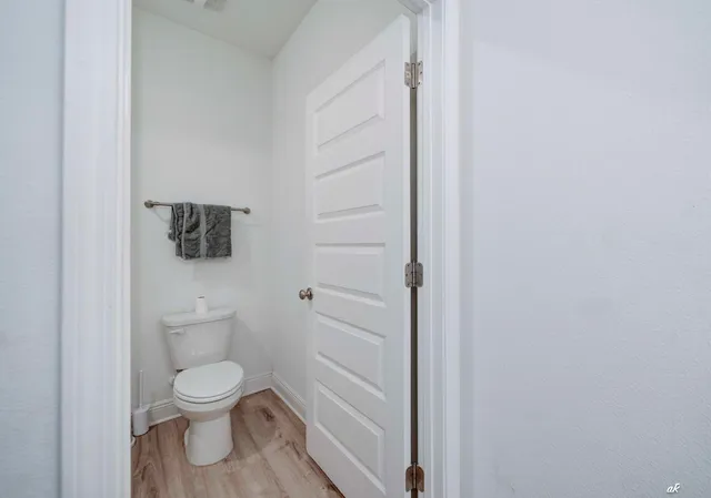 a white toilet sitting next to a shower
