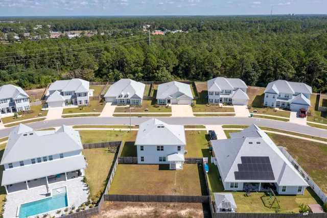 an aerial view of multiple houses with outdoor space