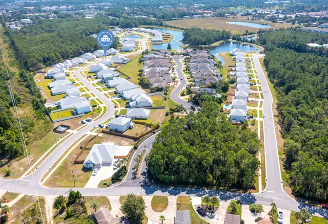 an aerial view of residential houses with outdoor space