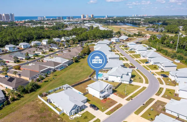 an aerial view of a house with a swimming pool and outdoor seating