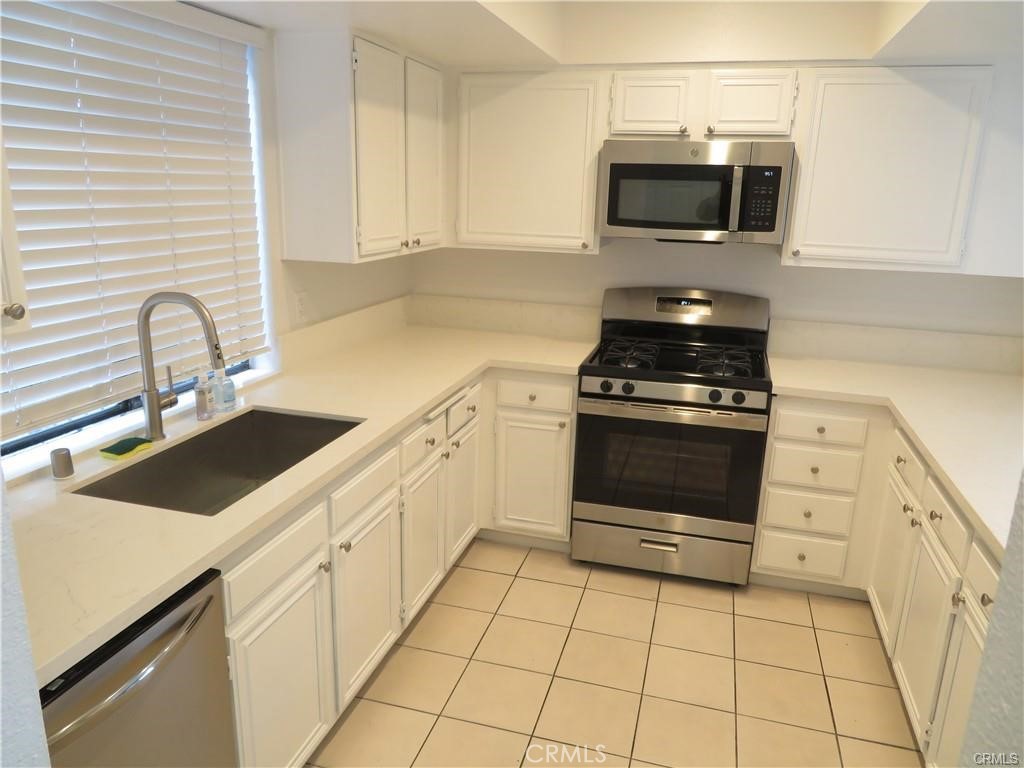 12415 Riverside Drive, Unit 1 Valley Village, CA 91607 - Photo 4 of 16 a kitchen with a stove and a microwave