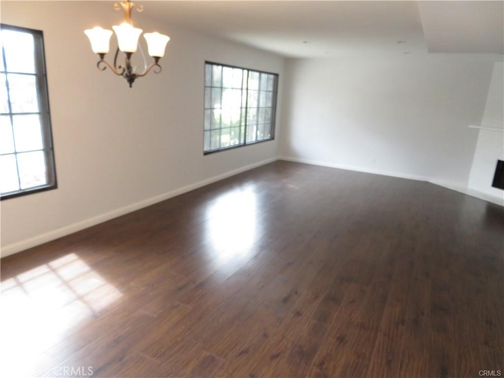 12415 Riverside Drive, Unit 1 Valley Village, CA 91607 - Photo 6 of 16 wooden floor in an empty room with a window