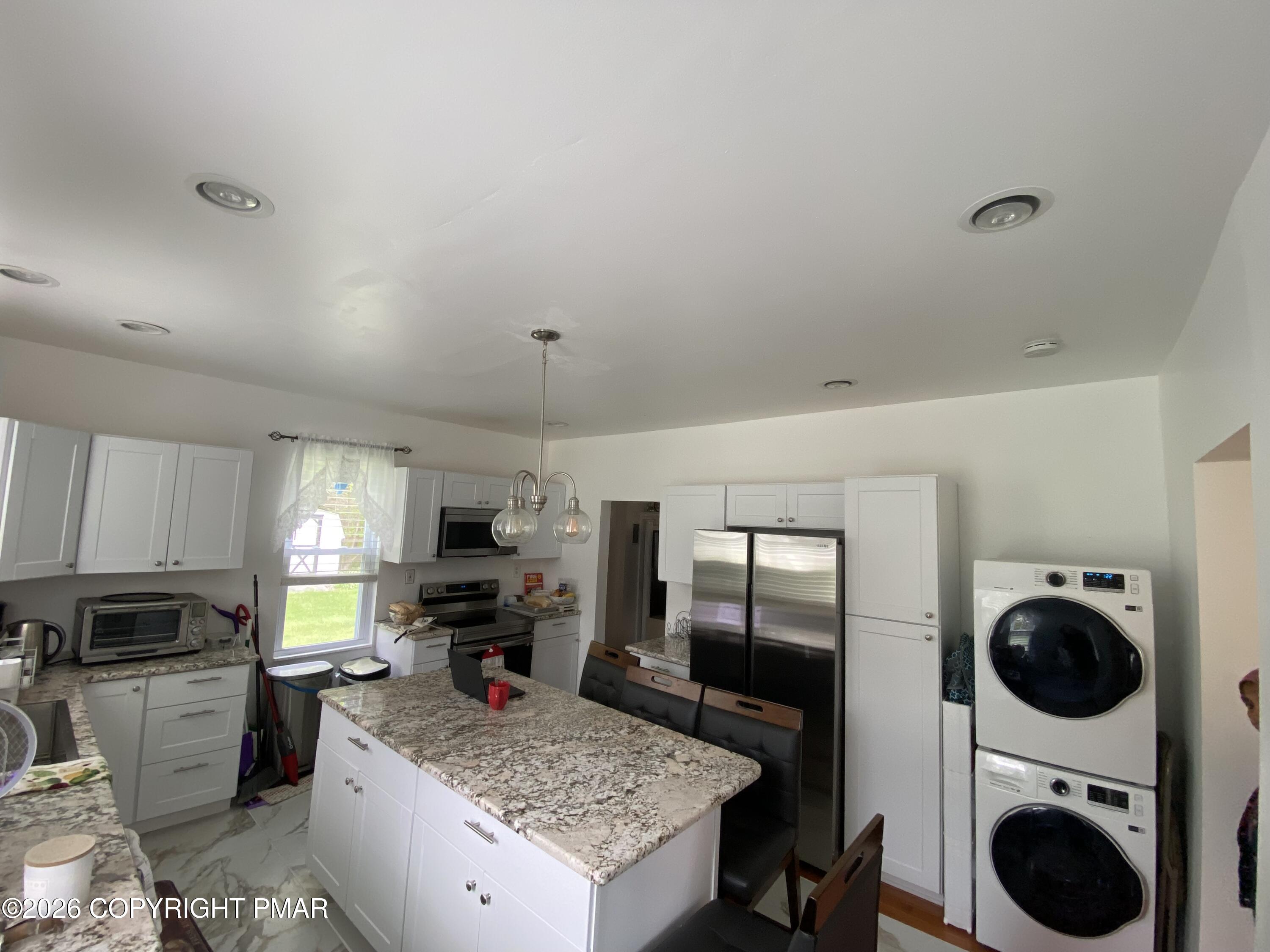 565 Cherry Lane Road East Stroudsburg, PA 18301 - Photo 7 of 16 a kitchen with refrigerator a stove and cabinets
