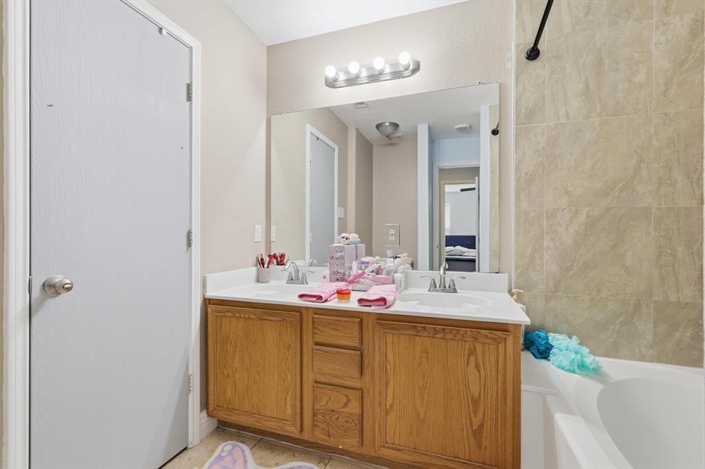 114 Drake Lane Garland, TX 75043 - Photo 16 of 27 a bathroom with a sink and a mirror