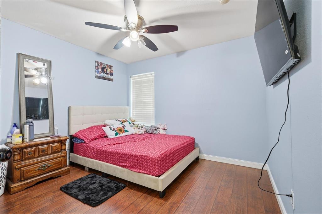 114 Drake Lane Garland, TX 75043 - Photo 18 of 27 a bedroom with a bed and a mirror on the dresser