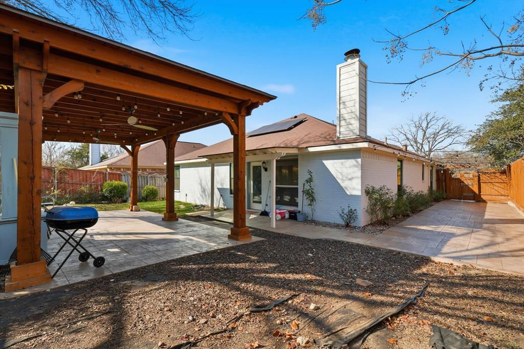 114 Drake Lane Garland, TX 75043 - Photo 23 of 27 a patio with a table and chairs under an umbrella