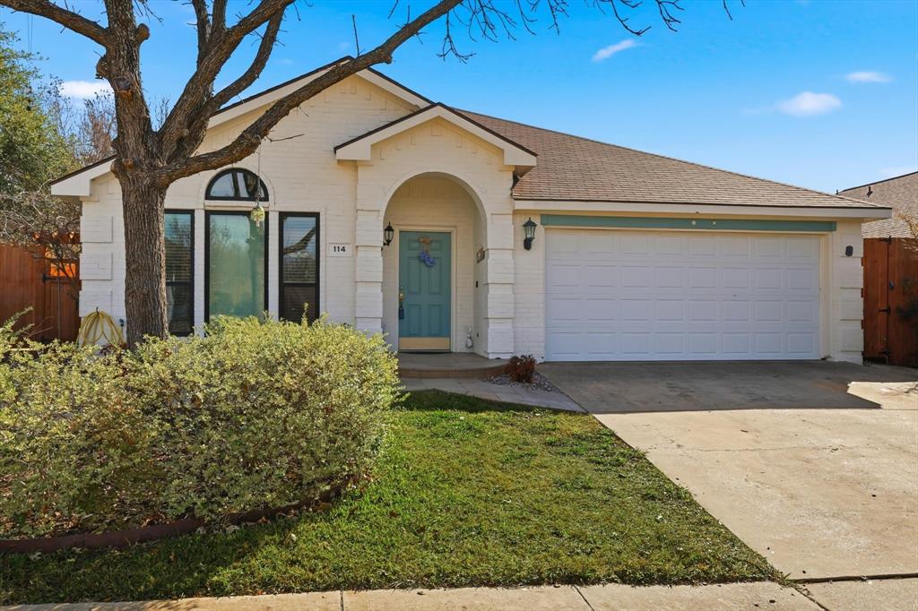 114 Drake Lane Garland, TX 75043 - Photo 3 of 27 a view of a white house with large windows and a small yard