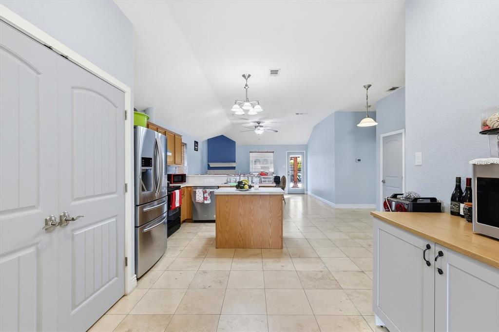 114 Drake Lane Garland, TX 75043 - Photo 9 of 27 a large kitchen with kitchen island a large counter space a sink appliances and cabinets