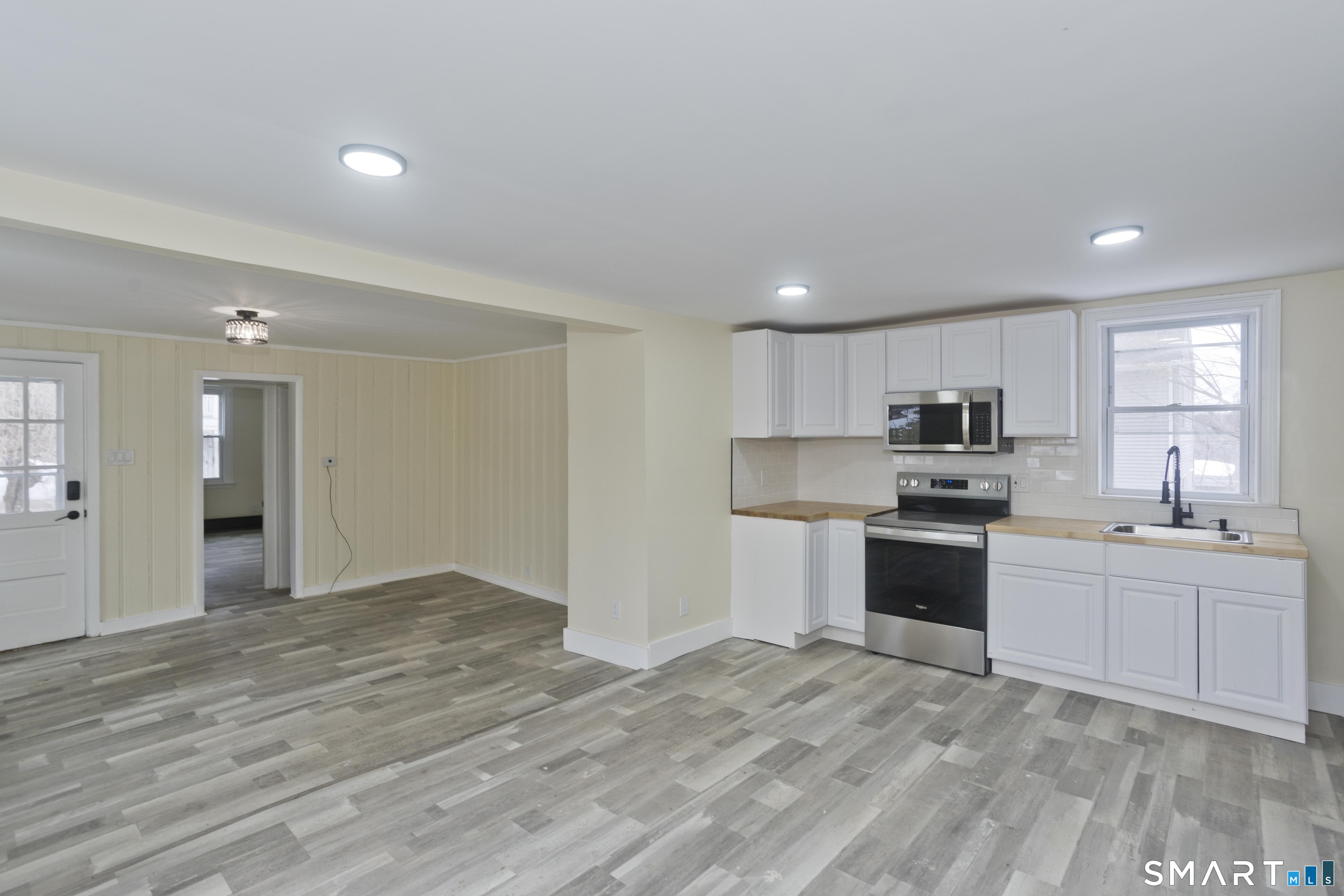 47 Maple Avenue Enfield, CT 06082 - Photo 22 of 36 a large white kitchen with kitchen island a sink stainless steel appliances and cabinets