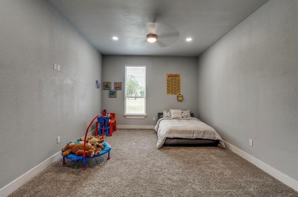 997 Ovilla Road Waxahachie, TX 75167 - Photo 21 of 32 Carpeted room featuring a ceiling fan with integrated lighting, recessed lighting fixtures, a single window with blinds, and white baseboards