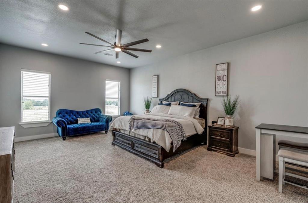 997 Ovilla Road Waxahachie, TX 75167 - Photo 23 of 32 Spacious bedroom featuring neutral wall tones, plush carpet flooring, recessed lighting, and a contemporary ceiling fan
