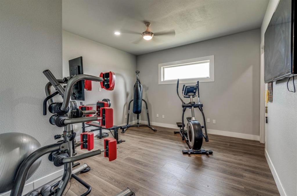997 Ovilla Road Waxahachie, TX 75167 - Photo 10 of 32 Spacious room featuring wood-finish flooring, a contemporary ceiling fan, and recessed lighting