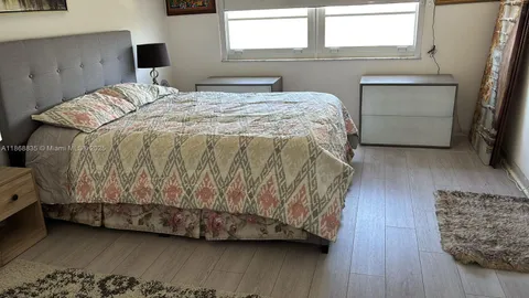 a bedroom with bed and window