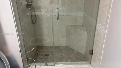 a bathroom with a granite countertop toilet sink and mirror