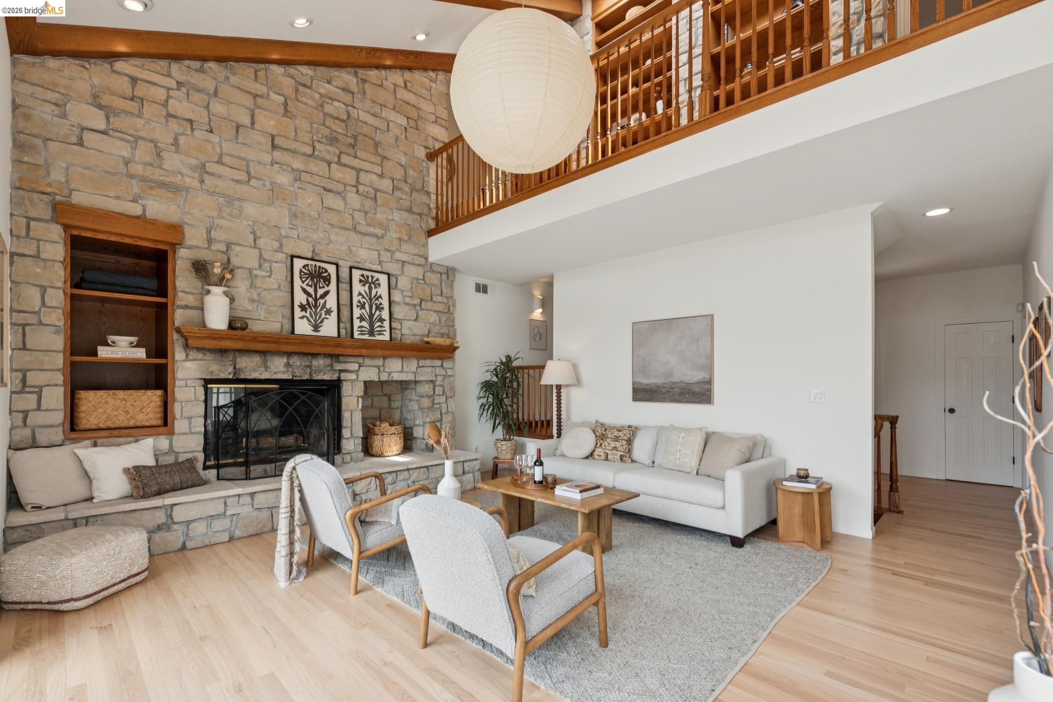 1325 Drury Road Berkeley, CA 94705 - Photo 13 of 71 Stone-clad fireplace extending to the vaulted ceiling with exposed wood beams