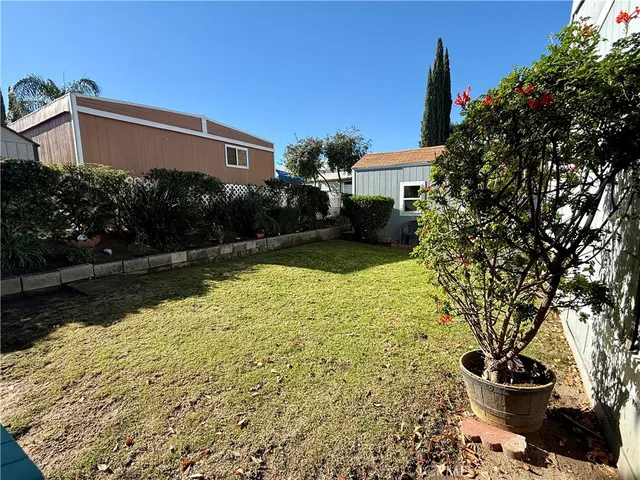 a view of a house with a yard and a fountain