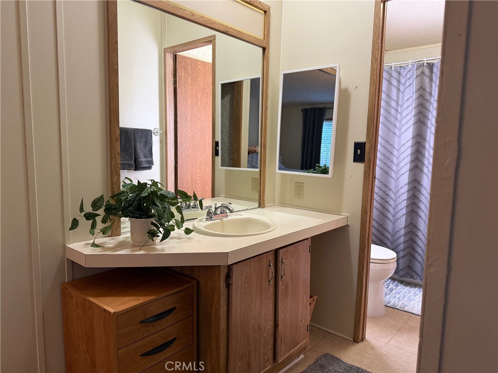 1550 Rory Simi Valley, Unit 80 Simi Valley, CA 93063 - Photo 6 of 11 a bathroom with a sink and a mirror
