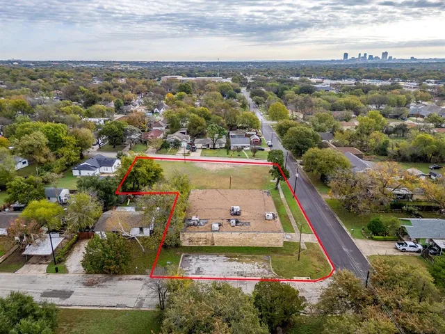 an aerial view of residential houses with outdoor space and swimming pool