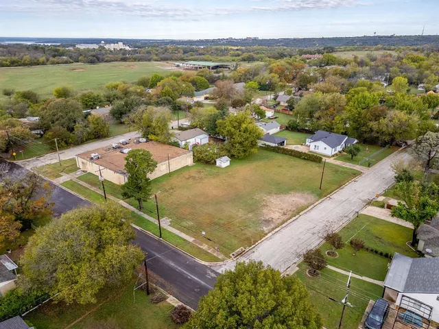an aerial view of residential houses with outdoor space and river