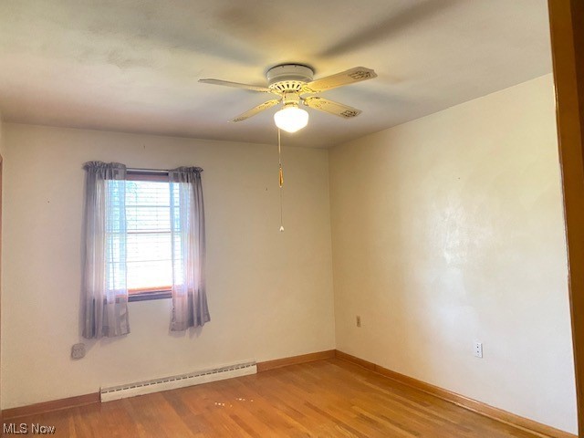 1772 Bantam Ridge Road Steubenville, OH 43953 - Photo 14 of 43 Unfurnished room featuring a baseboard radiator, light hardwood / wood-style floors, and ceiling fan