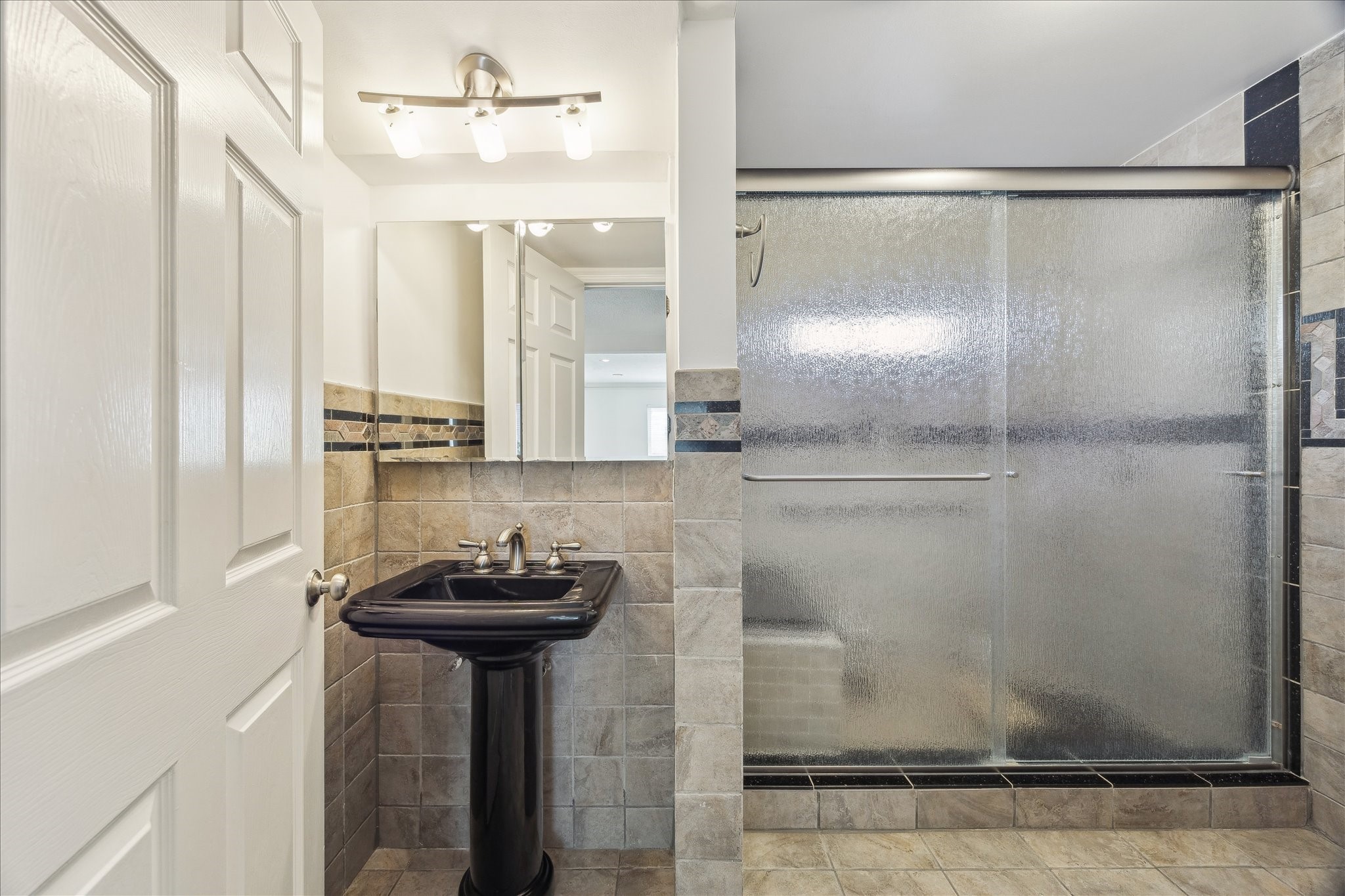 4388 Fiesta Lane Houston, TX 77004 - Photo 18 of 24 a bathroom with a mirror and a shower