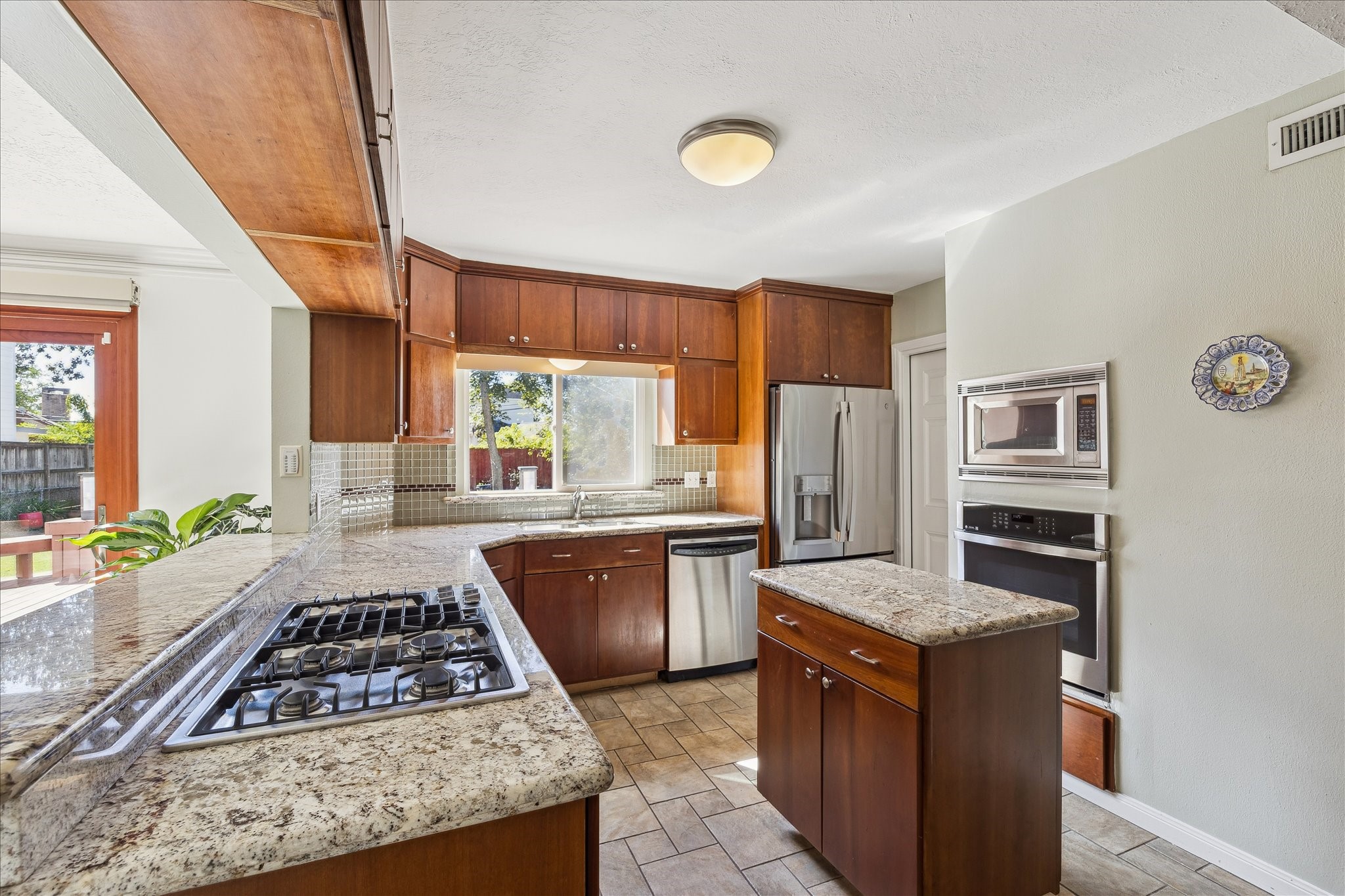 4388 Fiesta Lane Houston, TX 77004 - Photo 9 of 24 a kitchen with stainless steel appliances granite countertop a stove a sink dishwasher and a refrigerator