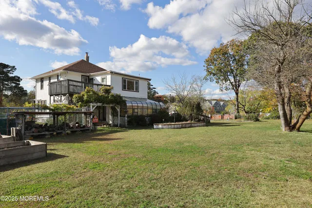 a front view of a building with cars parked