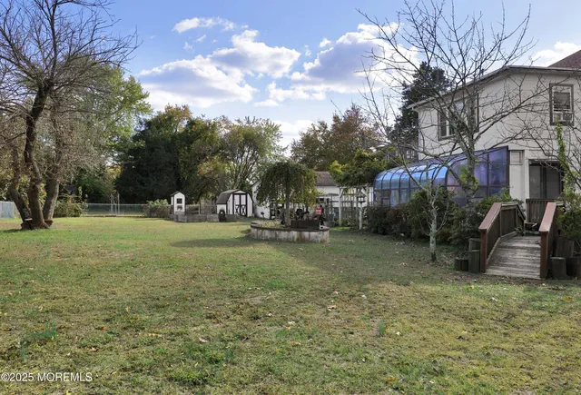 a view of outdoor space with deck and yard