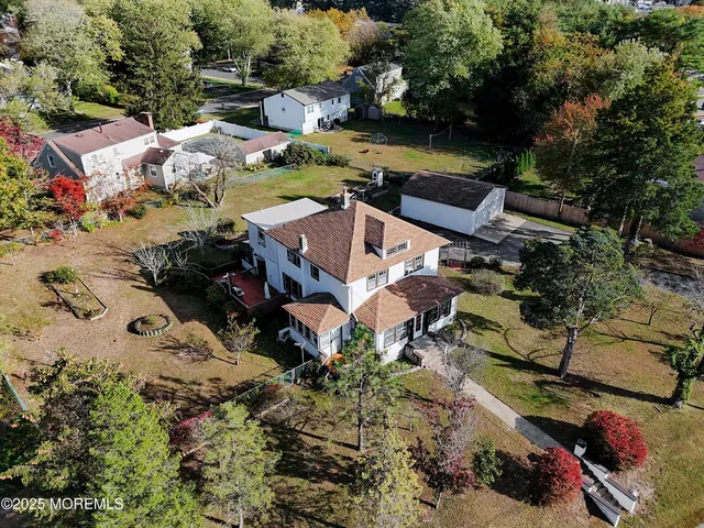 an aerial view of a house with yard swimming pool and outdoor seating